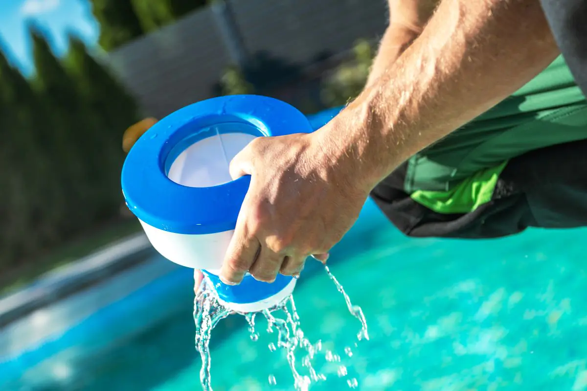 men removing chemical dispenser from his pool to l 2026 01 08 22 36 15 utc